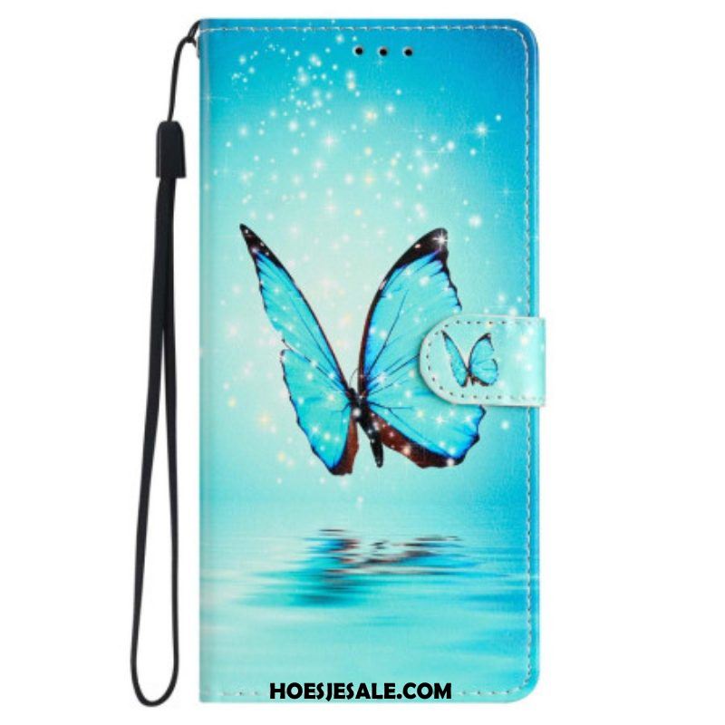 Folio-hoesje voor iPhone 15 Met Ketting Blauwe Vlinder Tijdens De Vlucht Met Riem